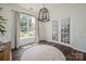 Sun-lit dining room featuring large window and french doors leading to the foyer at 115 Morrocroft Ln, Mooresville, NC 28117
