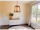 Charming dining room with large windows, stylish pendant lighting, and classic wainscoting, perfect for dining at 115 Morrocroft Ln, Mooresville, NC 28117