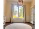 Bright dining room with large windows and classic chandelier, perfect for Gathering meals and gatherings at 115 Morrocroft Ln, Mooresville, NC 28117