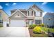 Charming two-story home with a well-manicured lawn, a two car garage, and inviting curb appeal at 115 Morrocroft Ln, Mooresville, NC 28117