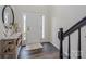 Bright foyer with entry door, side windows, dark hardwood floors, and black railing at 115 Morrocroft Ln, Mooresville, NC 28117