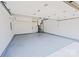 Spacious garage with a clean, epoxy-coated floor and ample storage space with an access door at 115 Morrocroft Ln, Mooresville, NC 28117