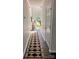 Long hallway with natural light and neutral decor, connecting the living spaces of this home at 115 Morrocroft Ln, Mooresville, NC 28117