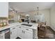 Modern kitchen featuring white cabinets, a marble countertop island, and stainless steel appliances at 115 Morrocroft Ln, Mooresville, NC 28117
