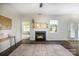 Bright living room with fireplace, ceiling fan, large window, and sliding glass door at 115 Morrocroft Ln, Mooresville, NC 28117