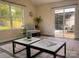 Bright living room with large windows and sliding glass doors to patio, offering relaxing indoor-outdoor living at 115 Morrocroft Ln, Mooresville, NC 28117
