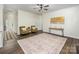 Spacious living room with neutral paint, ceiling fan, and view to the foyer at 115 Morrocroft Ln, Mooresville, NC 28117