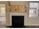 Inviting living room featuring a fireplace and a decorative mantel, creating a cozy ambiance at 115 Morrocroft Ln, Mooresville, NC 28117