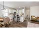 Open-concept living space with a kitchen bar, dining area, and hallway at 115 Morrocroft Ln, Mooresville, NC 28117