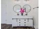 Main bathroom vanity with double sinks, storage, and modern round mirrors at 115 Morrocroft Ln, Mooresville, NC 28117