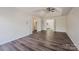 Spacious main bedroom with tray ceiling and views into the en suite bathroom and laundry room at 115 Morrocroft Ln, Mooresville, NC 28117