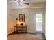 Bright home office featuring a modern desk, stylish lighting and a door that fills the room with natural light at 115 Morrocroft Ln, Mooresville, NC 28117