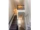 Beautiful staircase with dark wood railings leading to the second floor, enhanced by natural light and neutral decor at 115 Morrocroft Ln, Mooresville, NC 28117