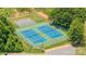 Aerial view of tennis and basketball courts surrounded by lush greenery in a vibrant community at 115 Morrocroft Ln, Mooresville, NC 28117