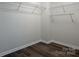 Walk-in closet featuring built-in wire shelving and wood-look flooring at 115 Morrocroft Ln, Mooresville, NC 28117