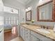 Bathroom with granite counters, double sinks, decorative mirrors and a door leading to the bedroom at 1169 Stuarts Landing Dr, Cramerton, NC 28032
