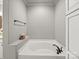 Bathroom featuring a large tub with tiled walls and dark bronze fixtures at 1169 Stuarts Landing Dr, Cramerton, NC 28032