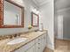 Bathroom with double sink vanity and granite countertops, featuring decorative mirrors and fixtures at 1169 Stuarts Landing Dr, Cramerton, NC 28032
