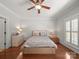 Bedroom featuring hardwood floors, ceiling fan, and windows with shutter-style blinds at 1169 Stuarts Landing Dr, Cramerton, NC 28032