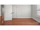Bedroom with hardwood floors, two doors, and a window with blinds at 1169 Stuarts Landing Dr, Cramerton, NC 28032