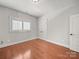 Cozy bedroom with hardwood floors, a window with shutters, and white trim at 1169 Stuarts Landing Dr, Cramerton, NC 28032