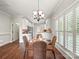 Bright dining room featuring hardwood floors, natural light, and a stylish chandelier at 1169 Stuarts Landing Dr, Cramerton, NC 28032