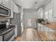 Kitchen with stainless appliances, granite countertops, white cabinets, and tile flooring at 1169 Stuarts Landing Dr, Cramerton, NC 28032