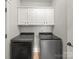 Functional laundry room featuring modern washer and dryer, and upper cabinets for storage at 1169 Stuarts Landing Dr, Cramerton, NC 28032
