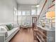 Bright living room featuring high ceilings, large windows, a comfortable seating area, and hardwood floors at 1169 Stuarts Landing Dr, Cramerton, NC 28032