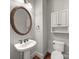 Stylish powder room with a decorative mirror, pedestal sink, and modern fixtures at 1169 Stuarts Landing Dr, Cramerton, NC 28032