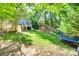 Beautifully landscaped backyard features green grass and leads up to a deck with stairs at 12004 Woodholm Ct, Tega Cay, SC 29708