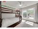 Bright bedroom with bunk beds, large windows, and natural light, creating a cozy space for children at 12004 Woodholm Ct, Tega Cay, SC 29708