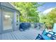 Outdoor deck with seating, a grill, and lush greenery, ideal for relaxing and entertaining at 12004 Woodholm Ct, Tega Cay, SC 29708