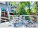 Spacious outdoor deck with a dining table and chairs, surrounded by lush greenery, perfect for outdoor dining at 12004 Woodholm Ct, Tega Cay, SC 29708