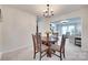Cozy dining room with wood table, chandelier, and view to living room at 12004 Woodholm Ct, Tega Cay, SC 29708