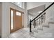 Inviting entryway with staircase, tiled floor, and decorative front door at 12004 Woodholm Ct, Tega Cay, SC 29708