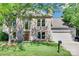 Charming brick two-story home with a well-manicured lawn and mature trees at 12004 Woodholm Ct, Tega Cay, SC 29708