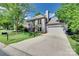 Charming two-story home with a brick facade, attached garage, large driveway, and manicured lawn at 12004 Woodholm Ct, Tega Cay, SC 29708