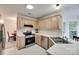 Well-lit kitchen with stainless steel appliances and light wood cabinets at 12004 Woodholm Ct, Tega Cay, SC 29708