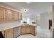 Open-concept kitchen with white countertops, and view to dining and entry areas at 12004 Woodholm Ct, Tega Cay, SC 29708
