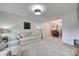 Bright living room open to dining area with neutral carpet at 12004 Woodholm Ct, Tega Cay, SC 29708