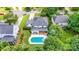 Aerial view of a home with an in-ground pool, grassy yard, mature trees, and well-maintained landscaping at 12416 Stirling Trace Ct, Charlotte, NC 28277
