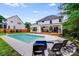 Spacious backyard with in-ground pool, lounge chairs, grassy area, and a well-maintained exterior at 12416 Stirling Trace Ct, Charlotte, NC 28277