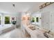 Large bathroom featuring a double vanity, soaking tub, separate shower, and ample natural light at 12416 Stirling Trace Ct, Charlotte, NC 28277
