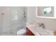 Modern bathroom features a glass-enclosed shower, stylish vanity, and a hexagon-patterned floor at 12416 Stirling Trace Ct, Charlotte, NC 28277