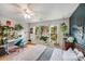 Bedroom featuring large windows, hanging chair, ceiling fan, and work desk at 12416 Stirling Trace Ct, Charlotte, NC 28277