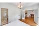 Bright bedroom featuring a chandelier, hardwood floors, and a bathroom, plus a pool table room at 12416 Stirling Trace Ct, Charlotte, NC 28277