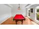 Bright room with hardwood floors and a red felt pool table at 12416 Stirling Trace Ct, Charlotte, NC 28277