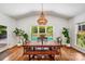 Dining area with backyard views, chandelier, and access to the outdoor area at 12416 Stirling Trace Ct, Charlotte, NC 28277