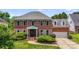 Charming two-story brick home with a well-manicured lawn and attractive landscaping at 12416 Stirling Trace Ct, Charlotte, NC 28277